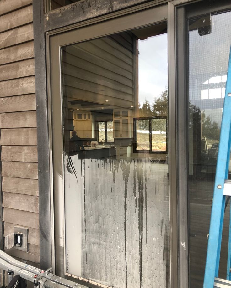 Close-up of exterior glass being washed with deionized water for a spot-free finish